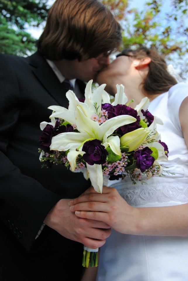 wedding photo of couple kissing while holding flowers, wedding flowers, lds wedding edmonton temple