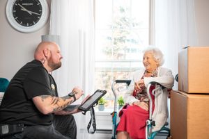 Moving company workers provide consultation in customer's living room.