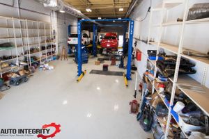 Large modern auto repair shop interior with lifts and equipment visible.