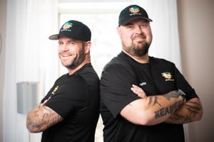 Team of movers in black uniforms with company logos display professional camaraderie.