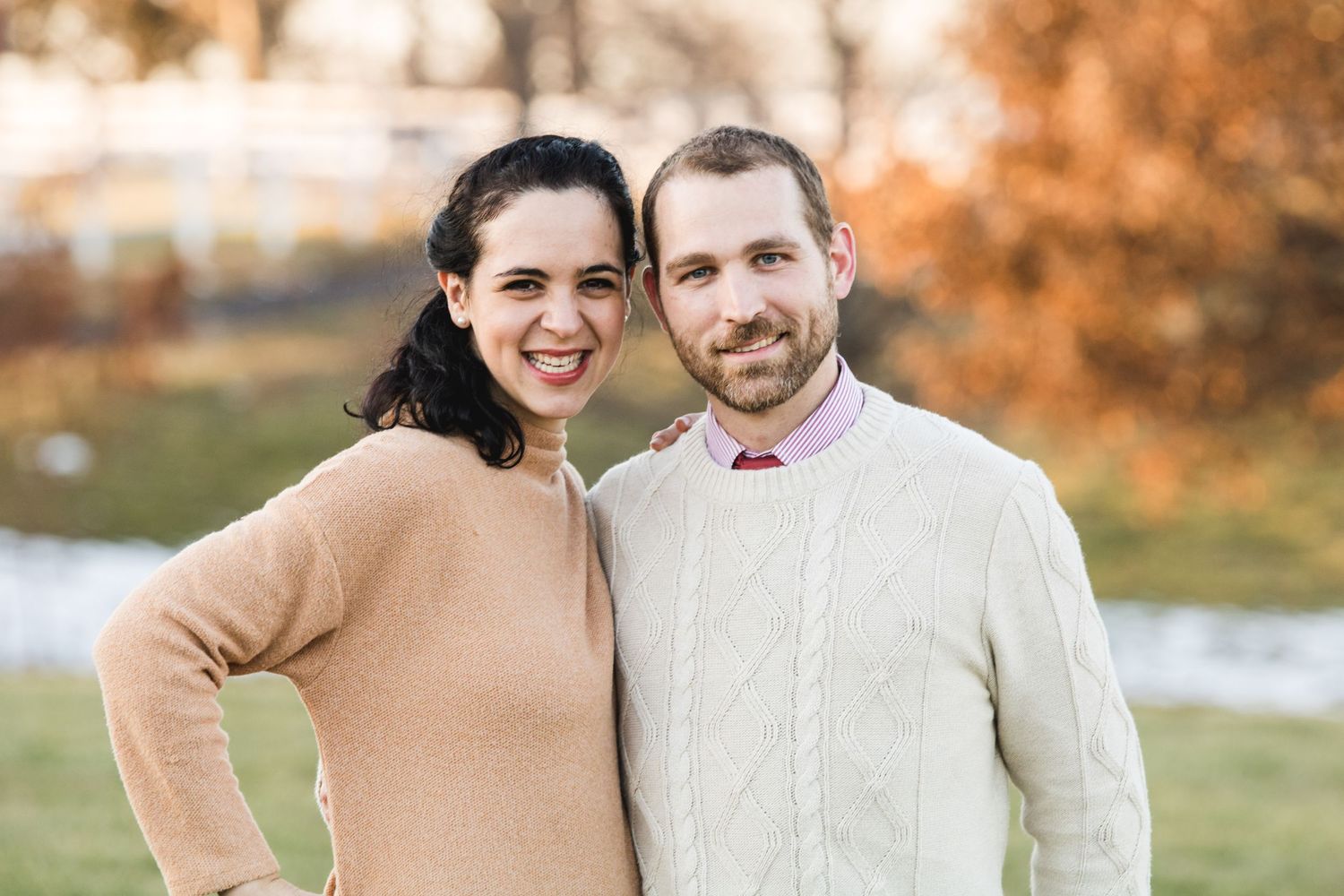 Picture of Isabel Nolan and her husband with an orange background.