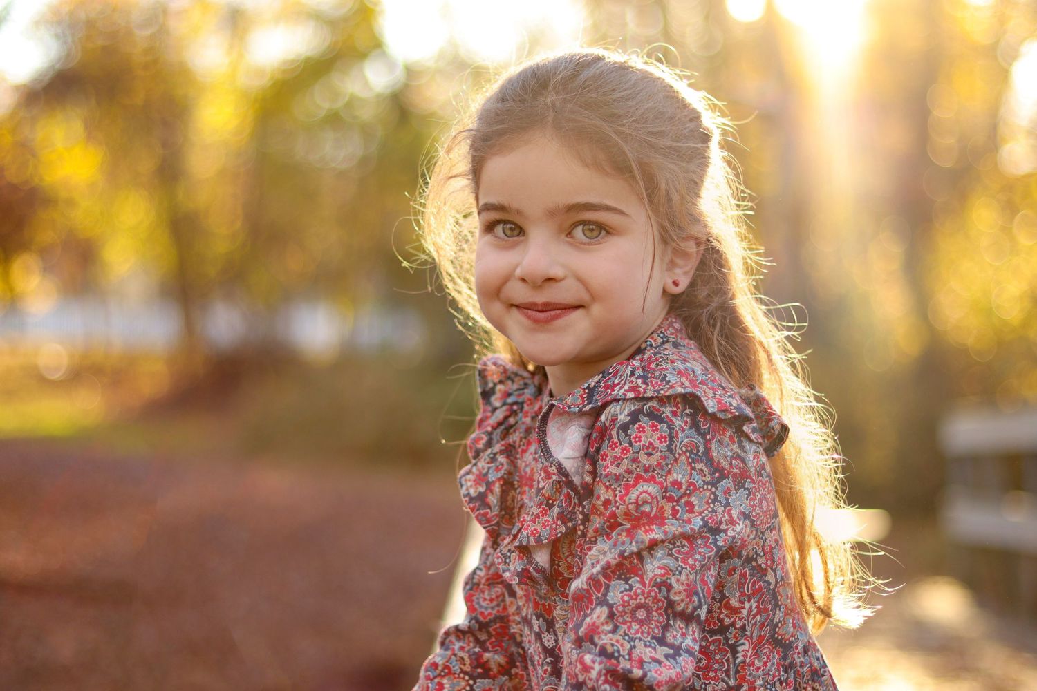 Portrait of a young girl in smiling during golden hour in autumn at South Lake Drive park, Lakewood, NJ