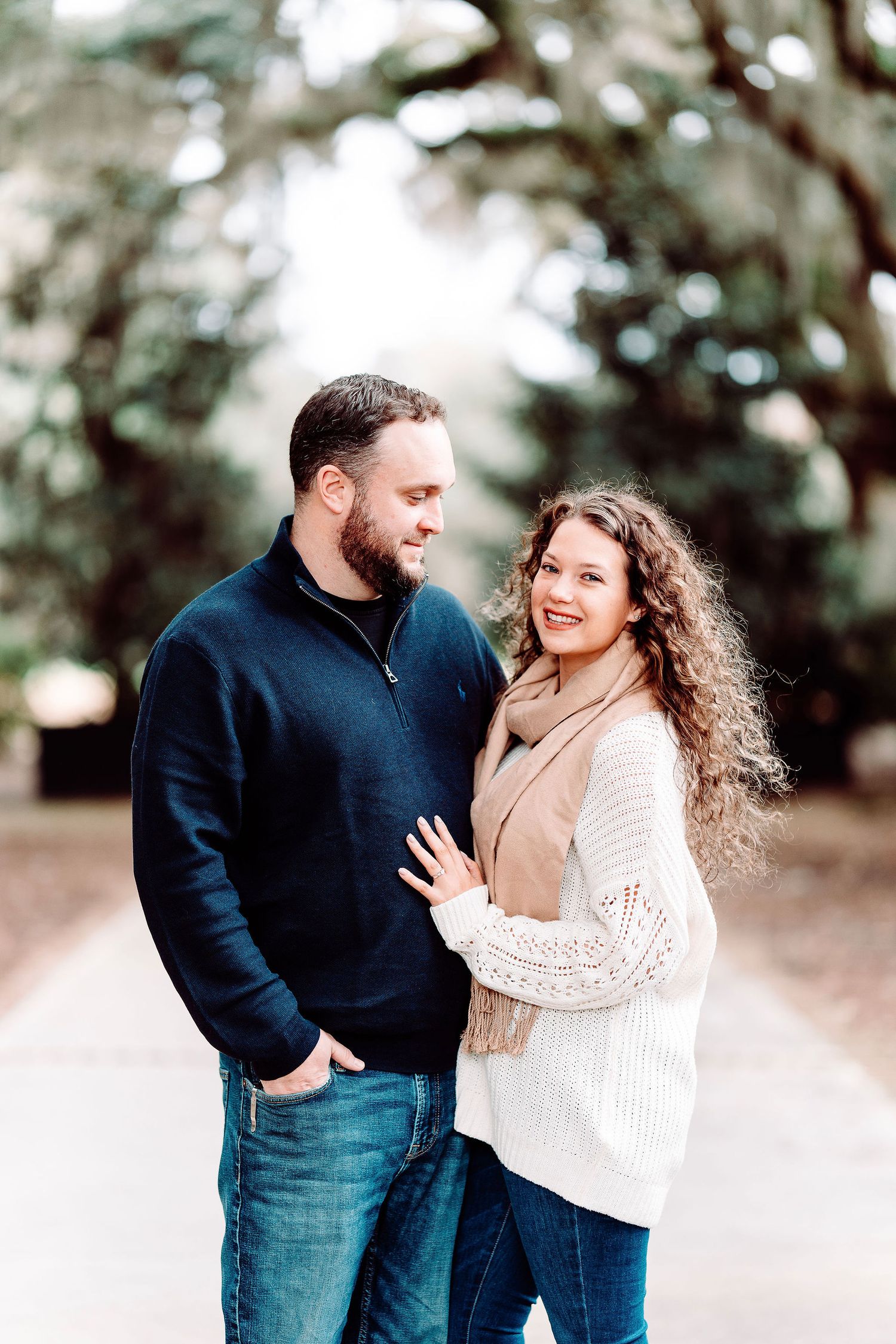 Couple shares joyful moment outdoors wearing casual winter sweaters.
