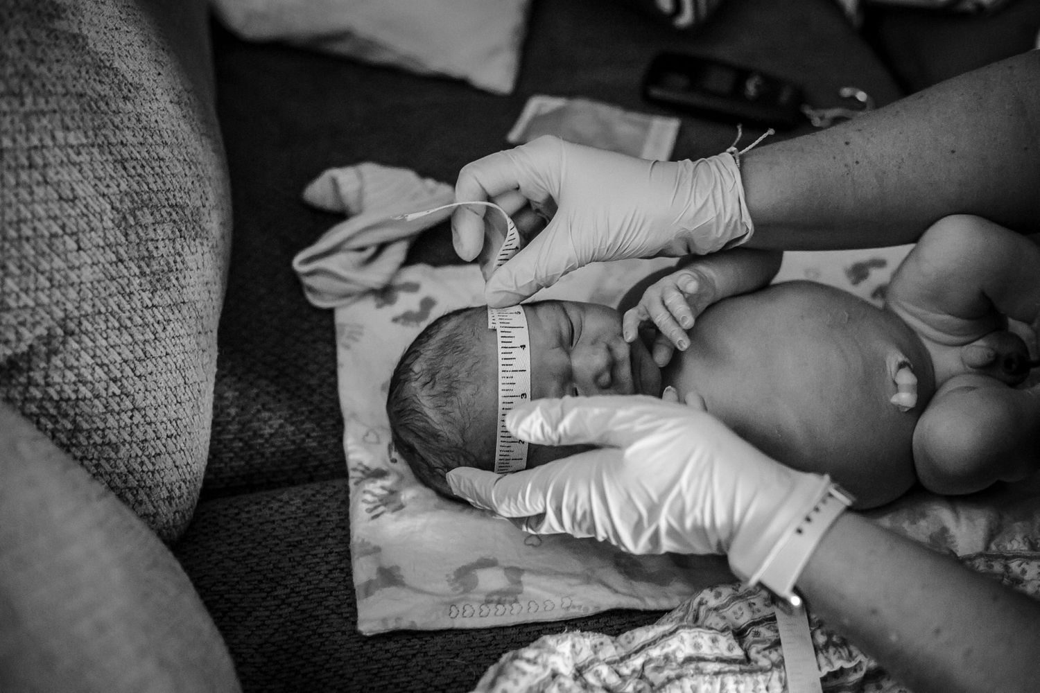 Midwife Kari from Sioux Center, IA measuring a newborn's head just after he was born at home near Kingsley, IA.