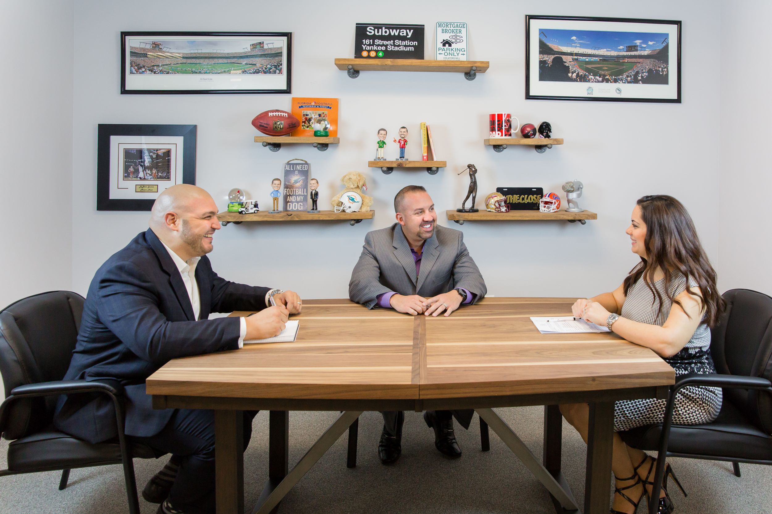 Business meeting scene in modern office with conference table and wall art.