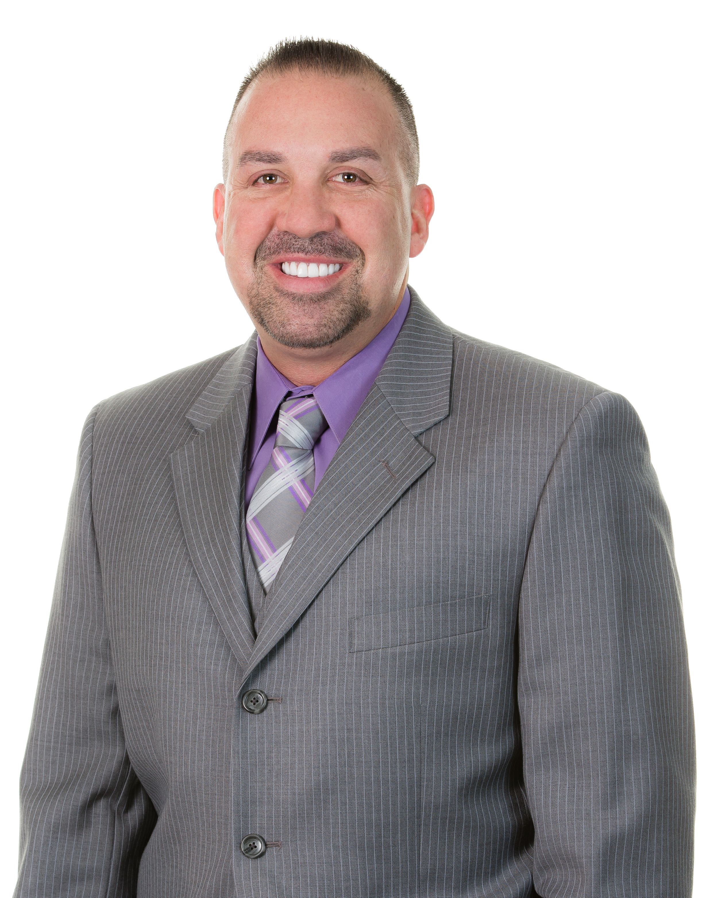 Three people in gray suits and purple ties pose professionally for a business portrait.