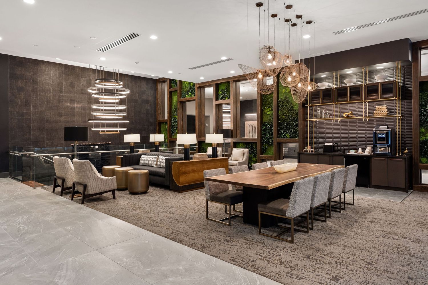 Modern apartment lobby lounge with sleek furniture, pendant lighting, and textured wall panels in contemporary design aesthetic.