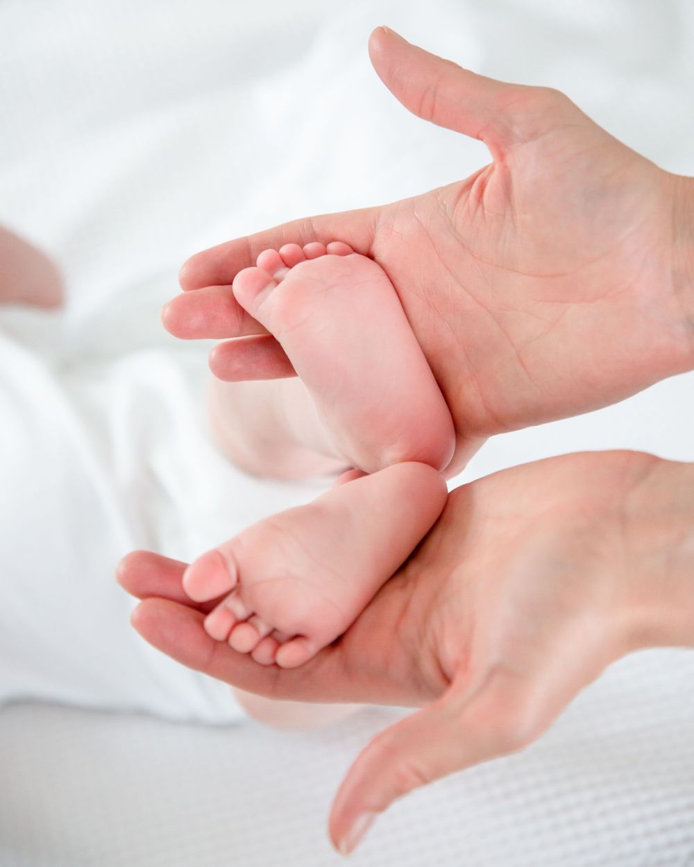 baby feet in mothers hands