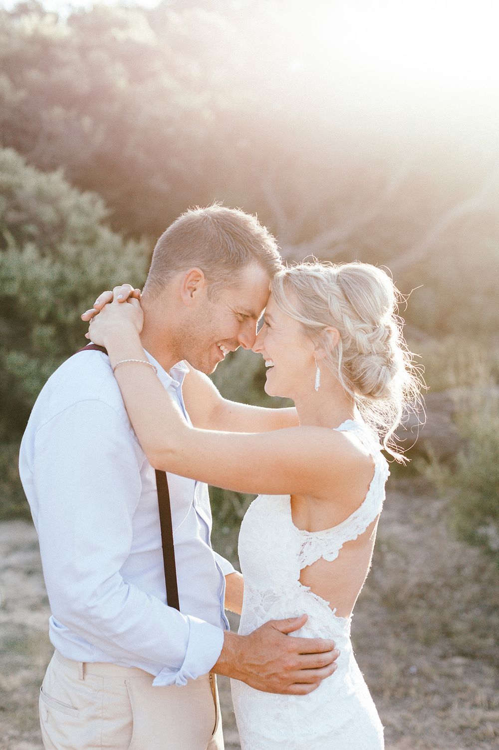 An intimate sunset portrait of a couple sharing a romantic embrace.