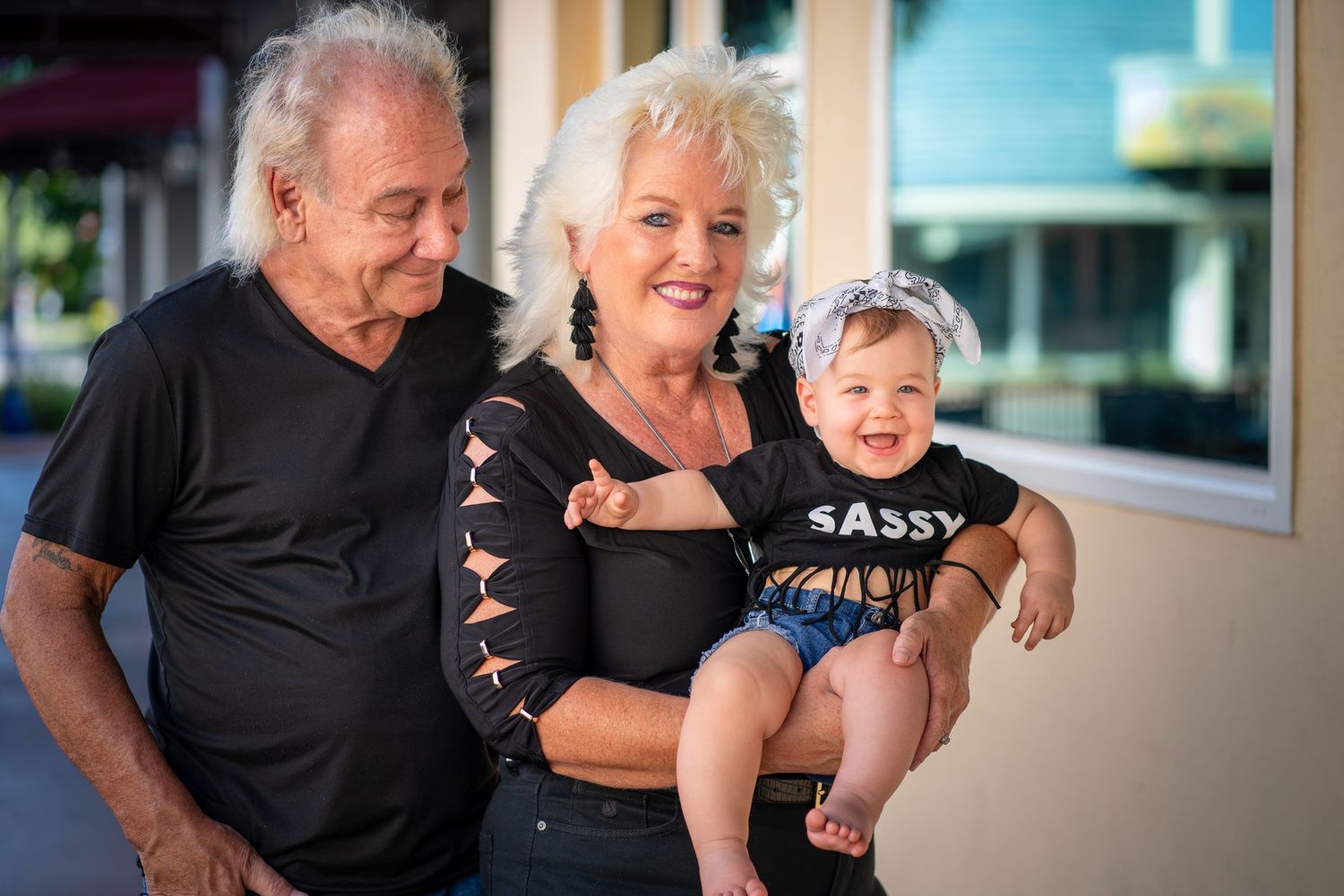 Three generations share a joyful moment together outdoors.