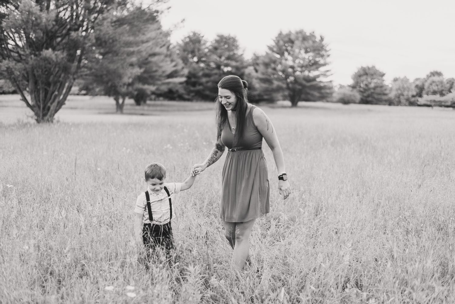 Mother and son running through field in black and white in Clarion Pennsylvania