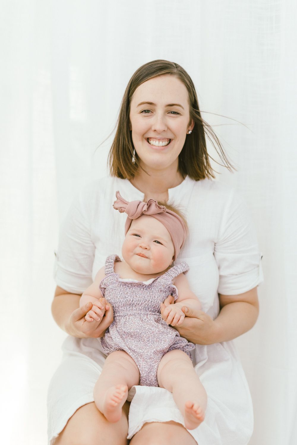 Joyful portrait against white background showing tender family moment.
