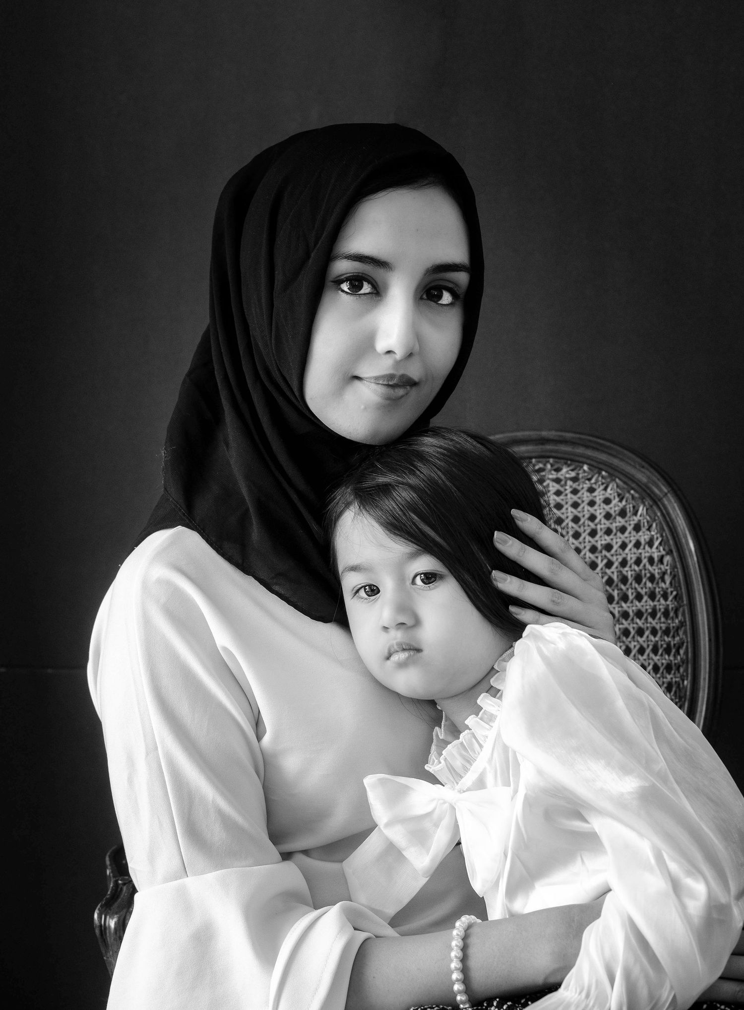 black and white image of mother with child during portrait session in queens, ny.