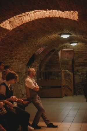 Arched brick cellar with ambient lighting during a wedding event.
