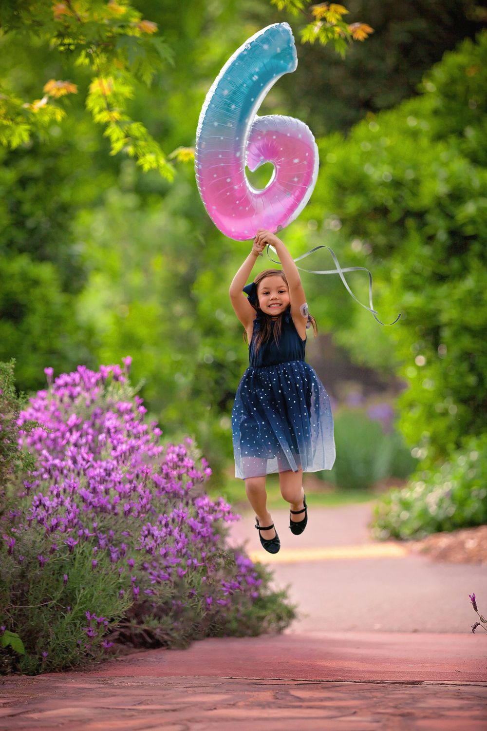 composite image of young girl birthday photo flying with balloon in Houston, TX