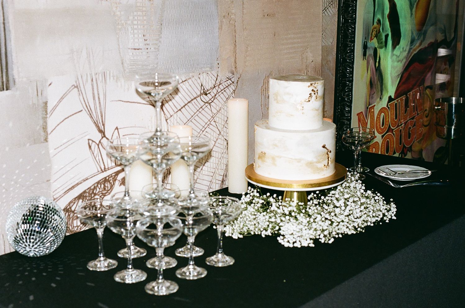 Elegant wedding reception display with champagne glasses and a white tiered cake.