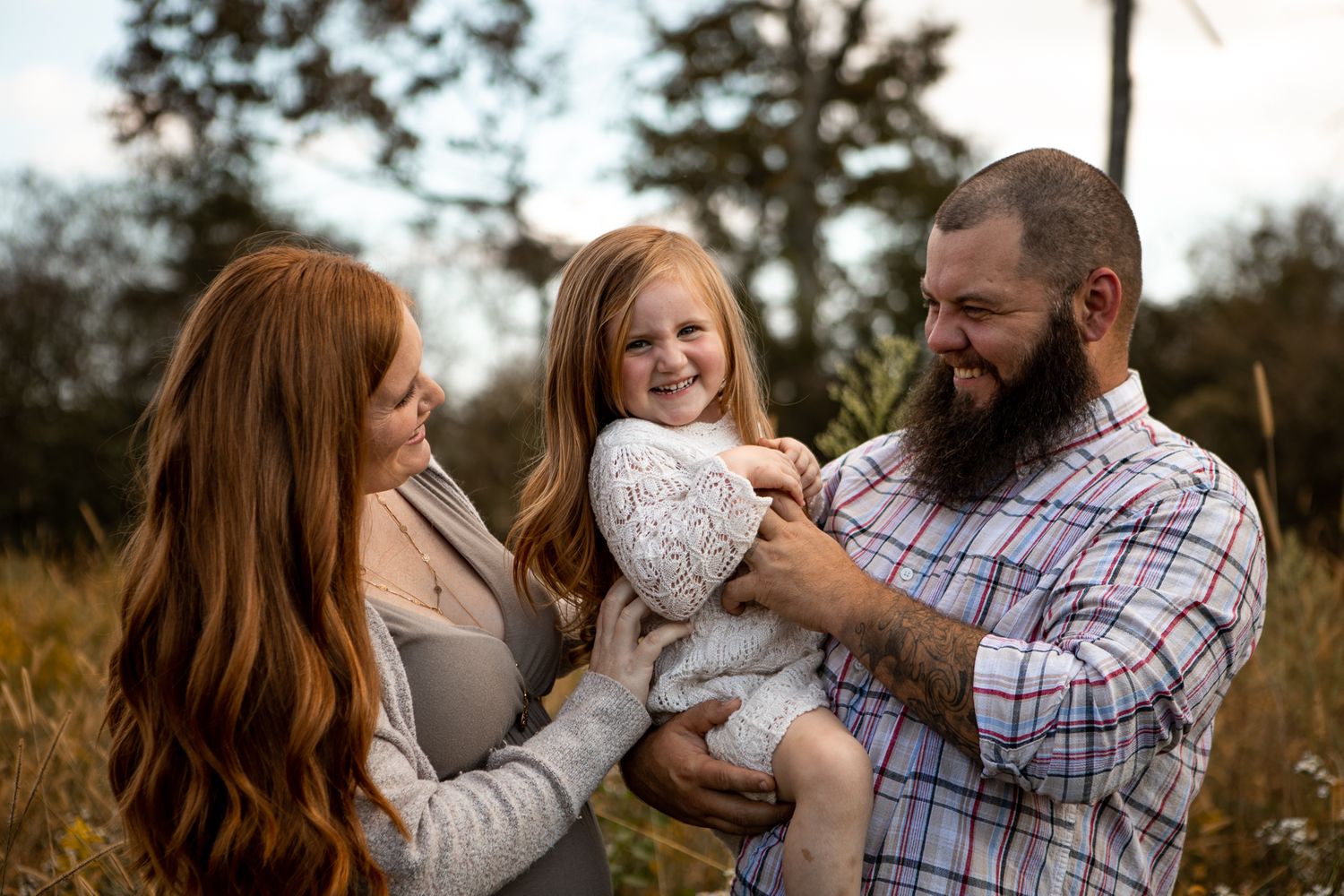 A family shares a joyful moment together outdoors during a lifestyle photoshoot.