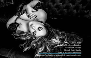 Artistic black and white boudoir photo featuring dramatic lighting and elegant lingerie.
