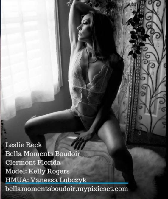 Artistic boudoir photo by window with lace details and soft natural lighting.