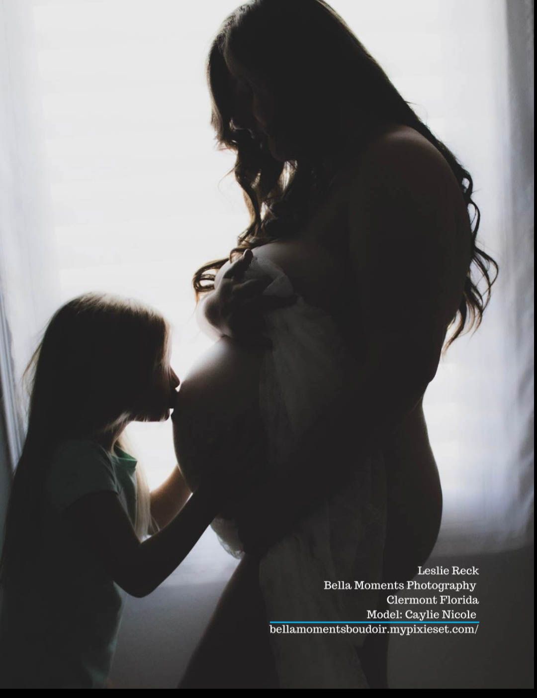Silhouette maternity photo showing intimate moment between mother and child.