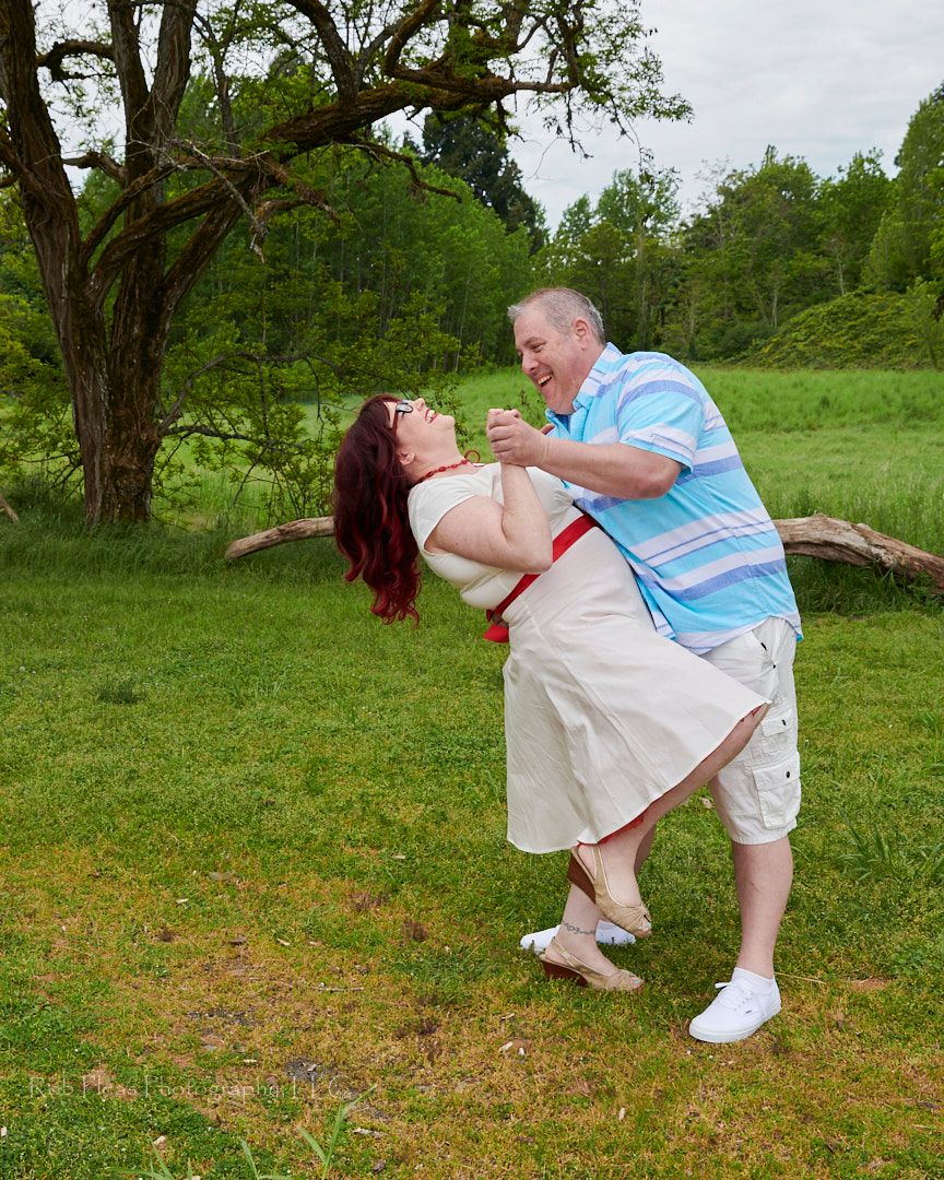 Wedding at Fort Steilacoom Park, Lakewood, WA.  Groom dipping bride.