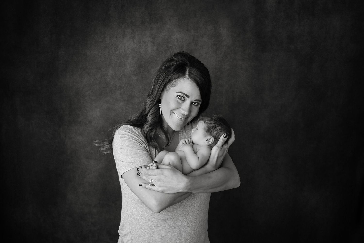 Intimate black and white portrait of mother and child sharing tender moment.