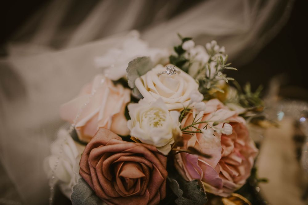 Elegant arrangement of pink and peach roses with delicate petals in soft lighting.