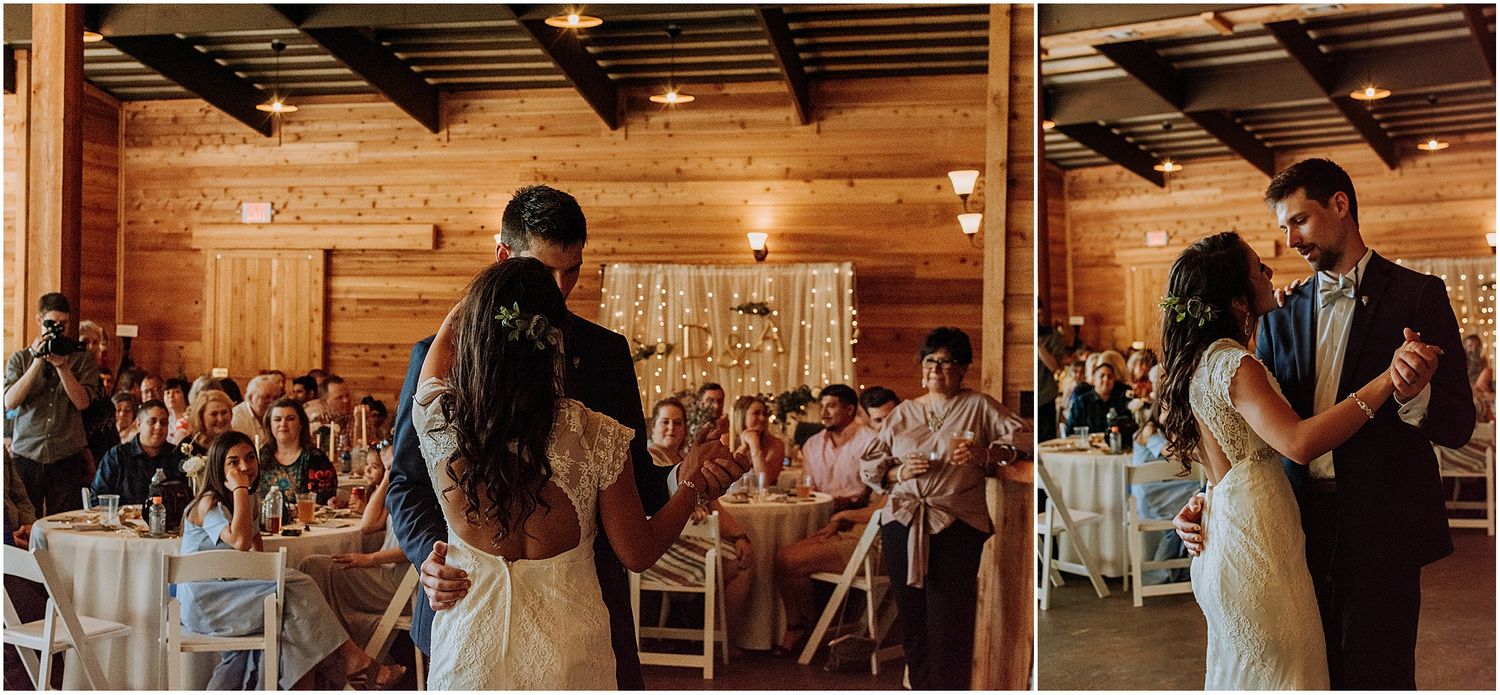 A romantic dance moment during a wedding reception in a wooden barn with natural lighting.
