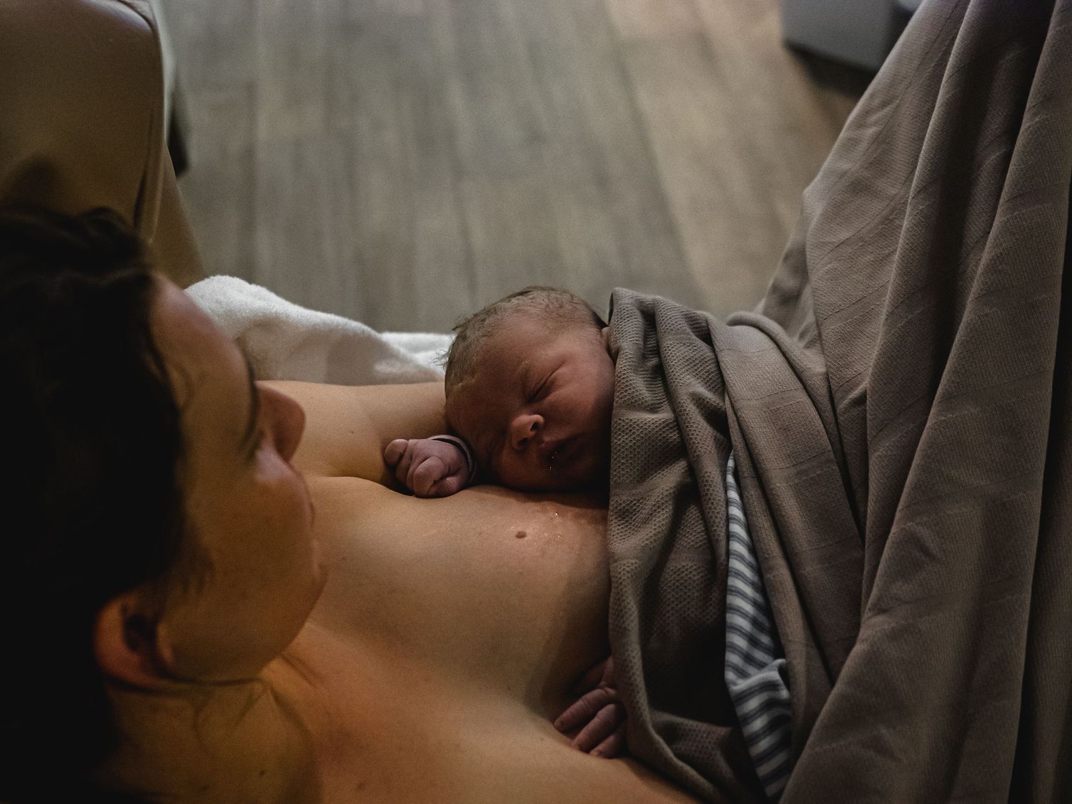 A mother holding her newborn baby in a birth centre after just giving birth in Perth