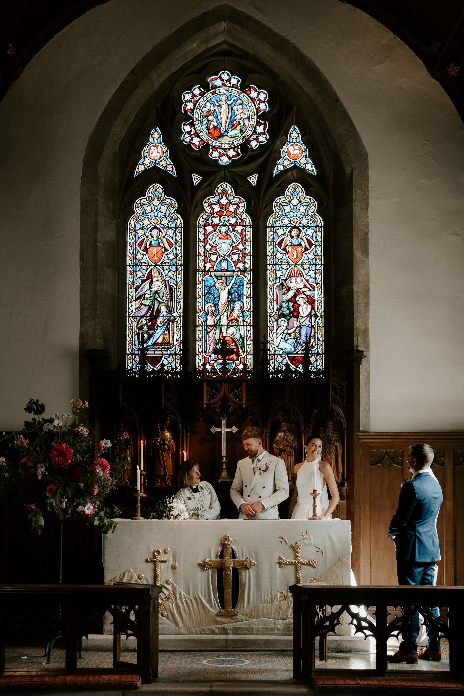 bride and groom at the alter before signing the wedding register at st Nicholas church in Oxfordshire