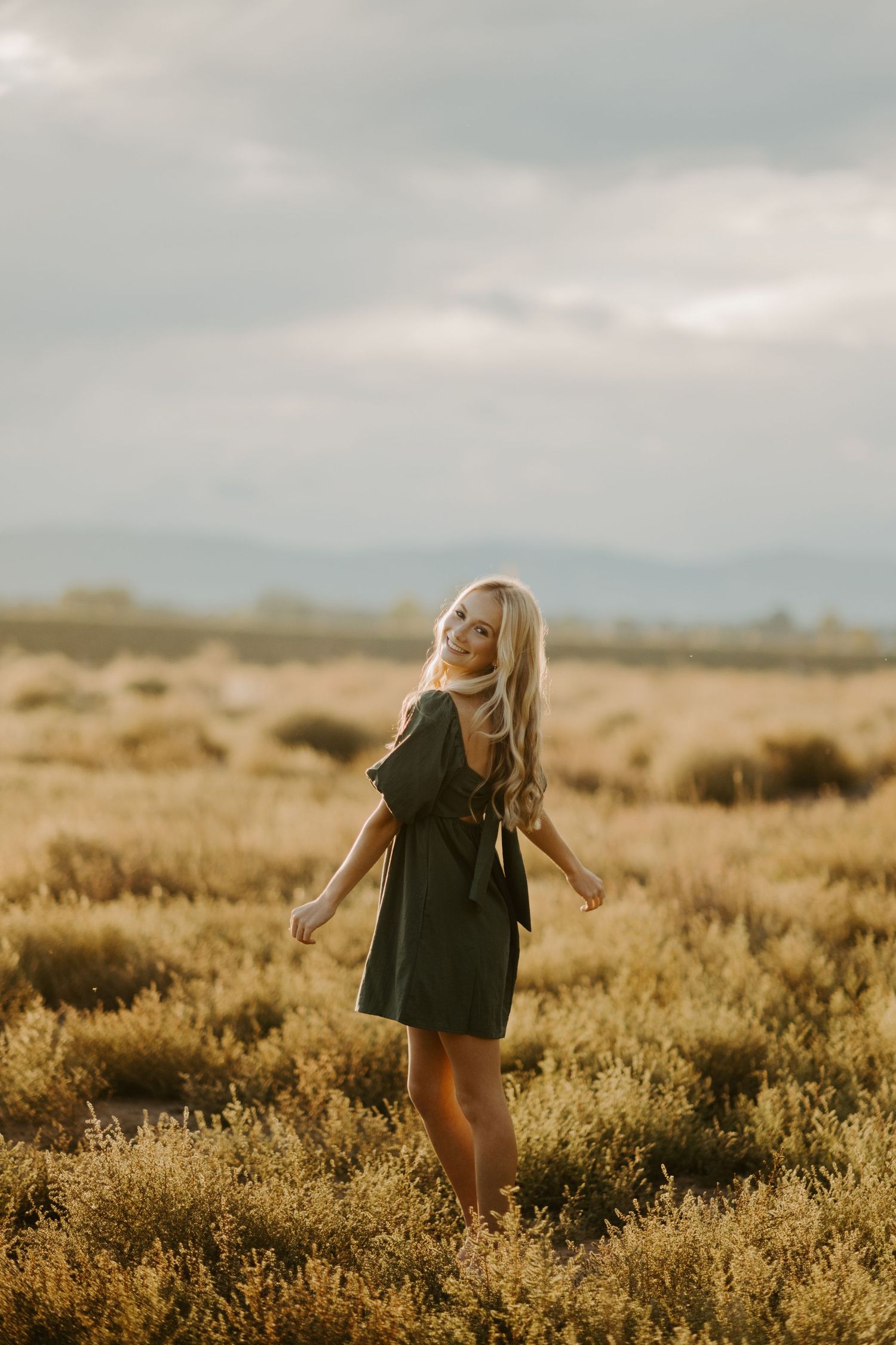 A senior girl poses during golden hour in Fort Collins Colorado