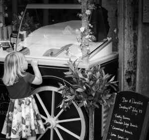 Wedding reception decor details with handwritten signs and floral arrangements.