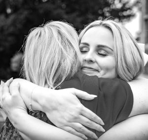 Series of black and white photos showing emotional wedding hugs and embraces.
