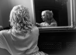 Black and white artistic shots showing preparation moments through window reflections.