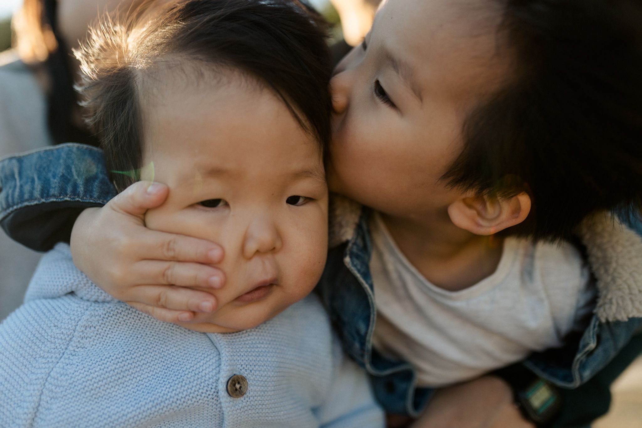 Brotherly cheek smush