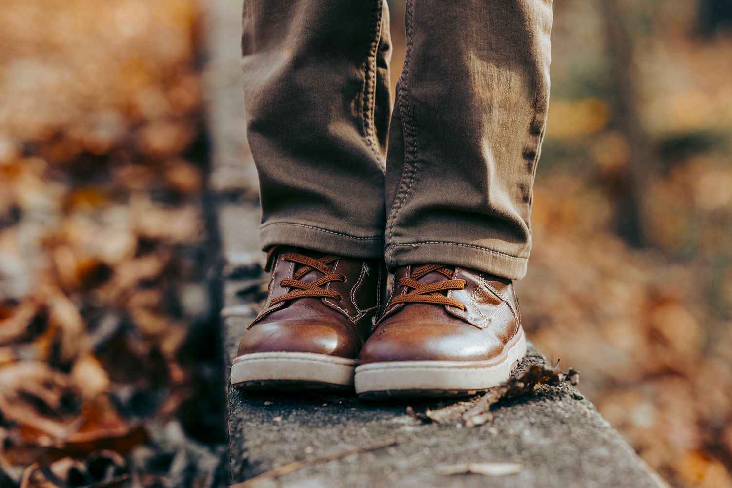 Bottom of boy's legs standing on a concrete slab in Salida, Colorado