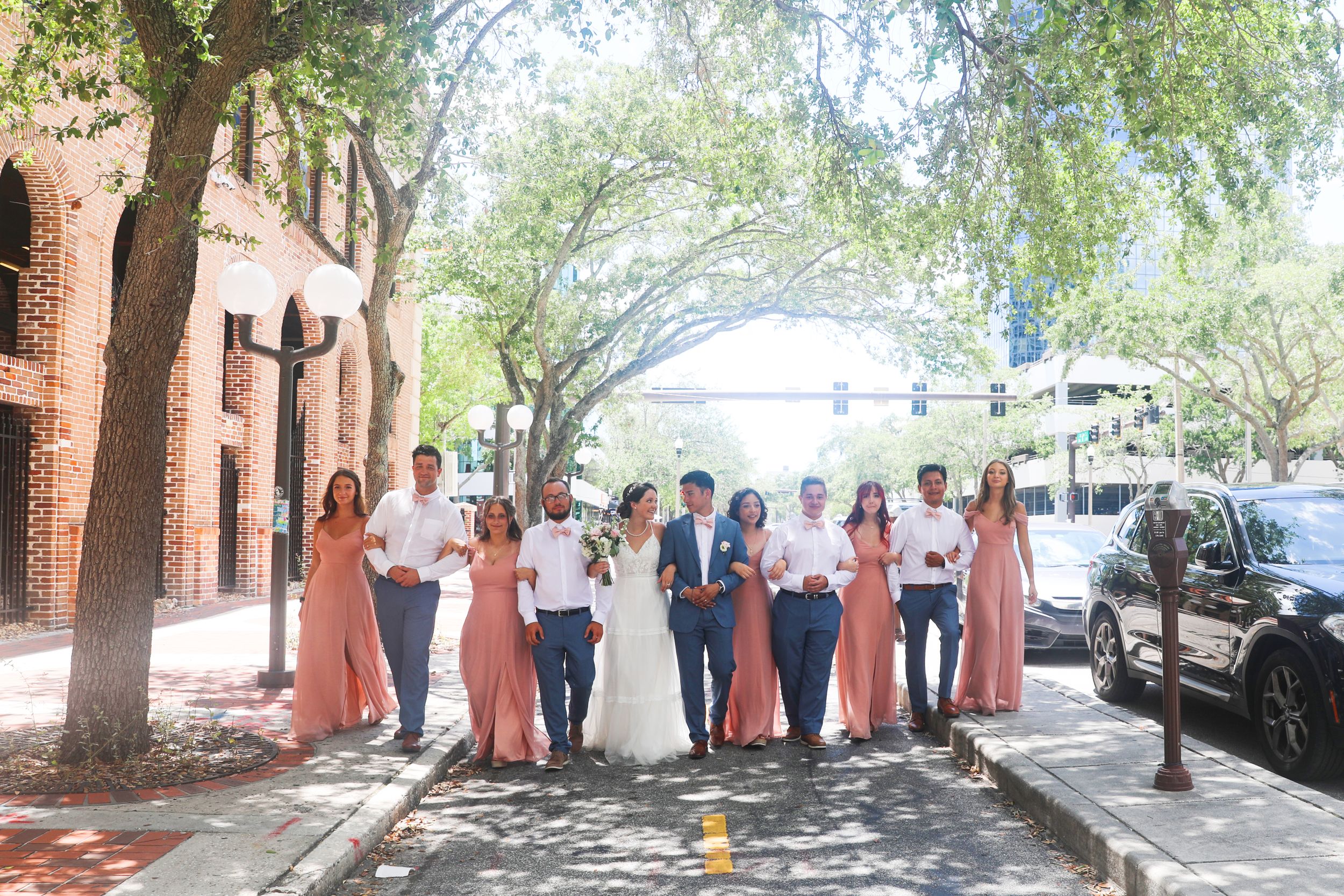 Wedding Party Street Portrait | Candid Celebration in Urban Setting

A joyful and stylish group moment unfolds as the wedding party walks