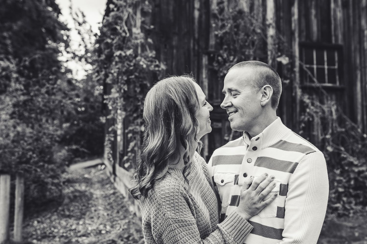 Two parents are going to kiss each other in Kirkland Washington for a family photography session