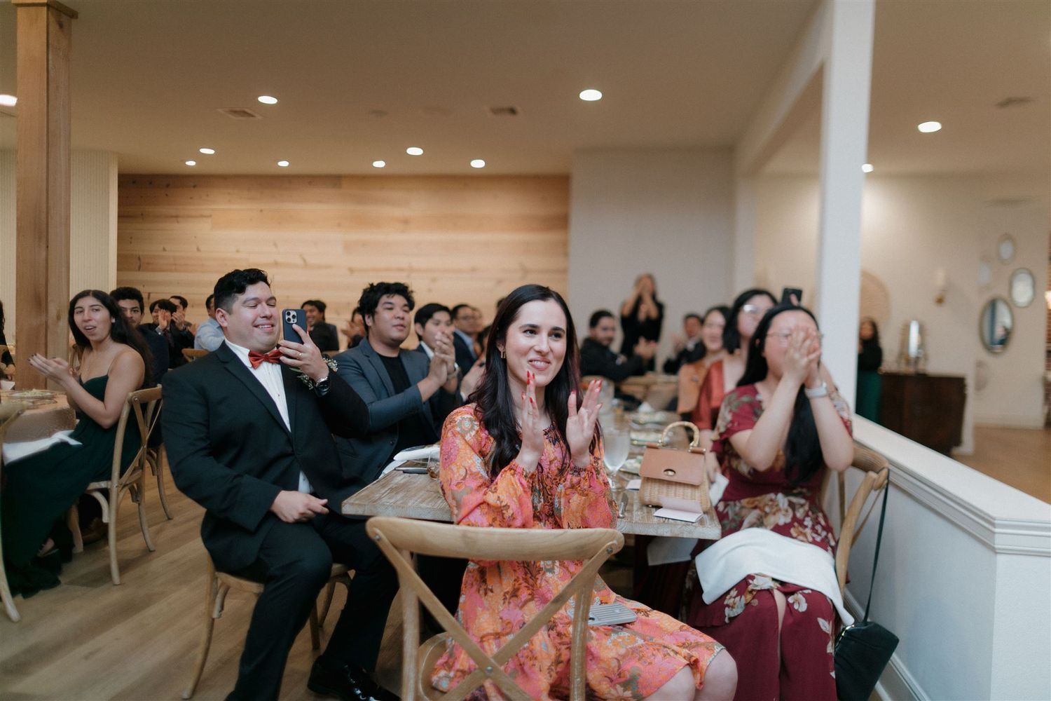 Wedding guests enjoying celebration in modern minimalist venue.