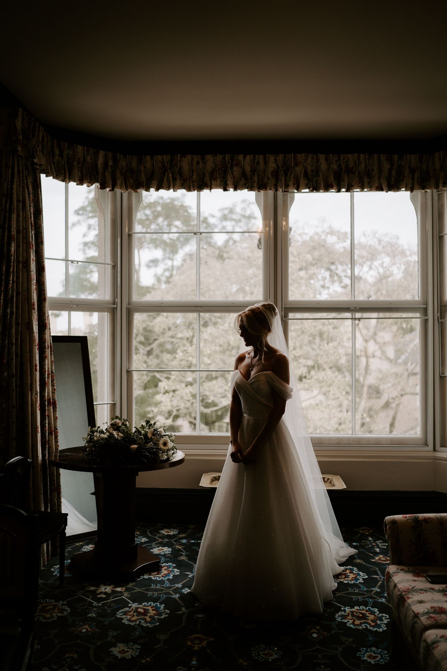 silhouette of bride stood in window at the Randolph hotel in Oxford
