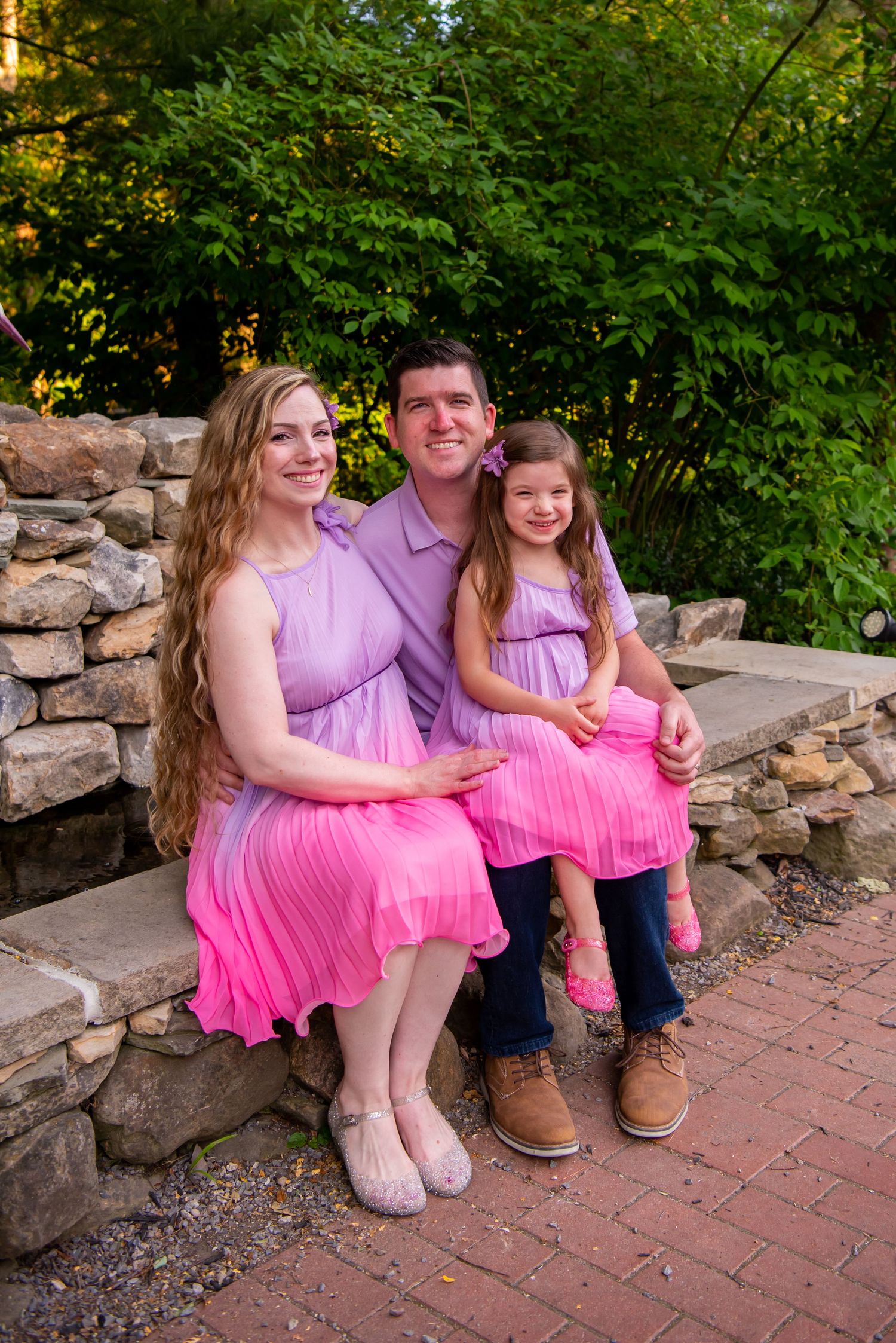 family photo sitting on rocks with four year old