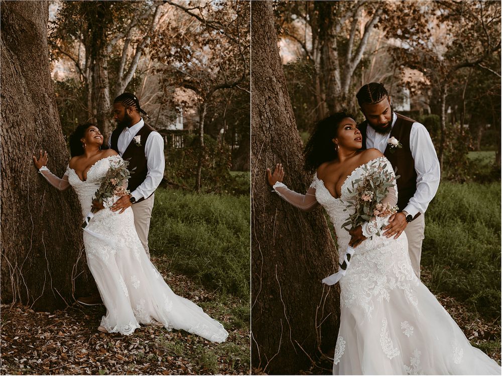 Wedding couple poses for romantic portraits against tree trunks in a natural outdoor setting.