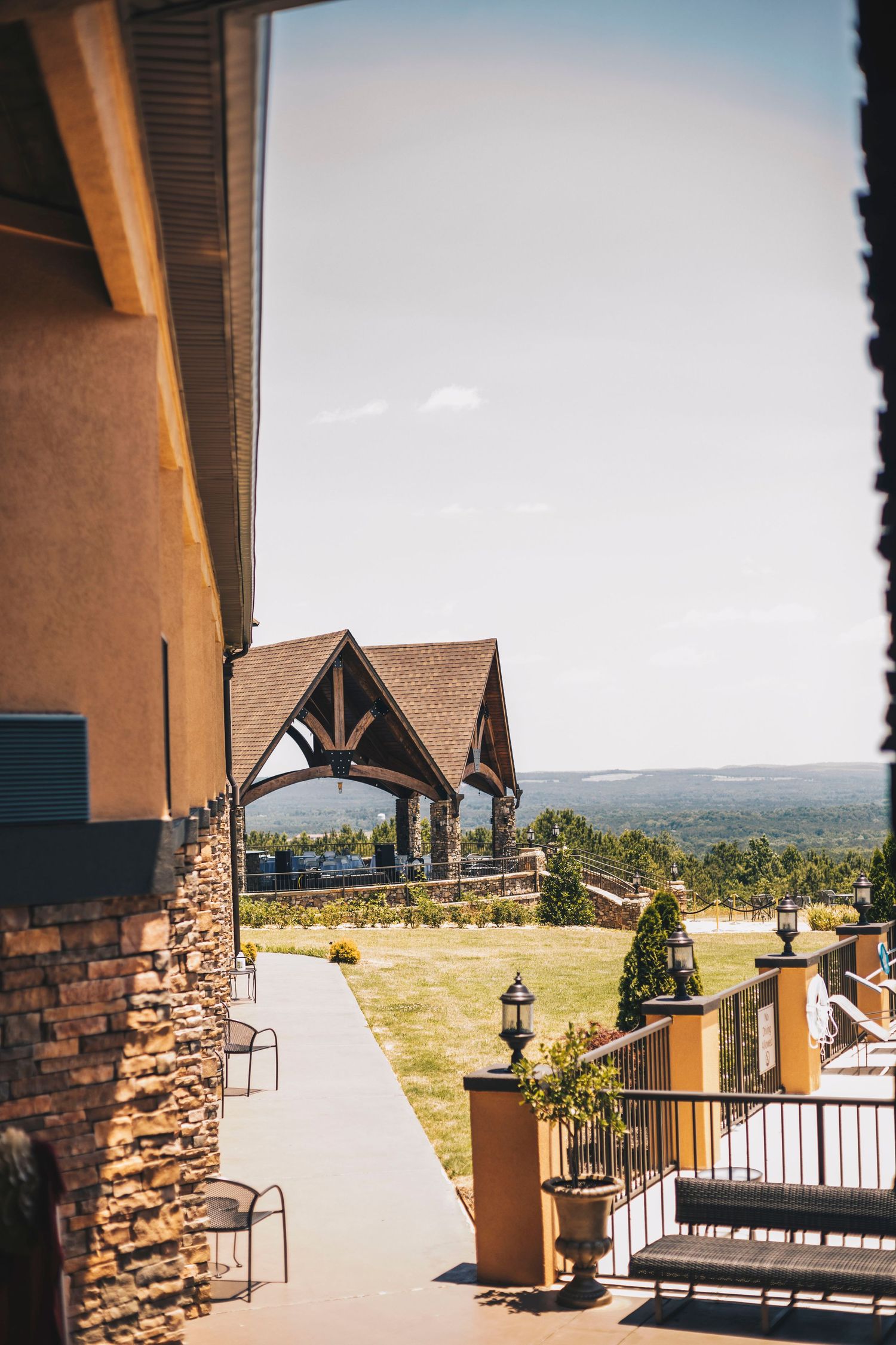 Scenic outdoor wedding venue with pavilion and panoramic countryside views on a sunny day.