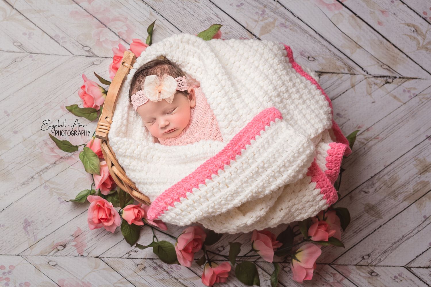 Newborn baby girl with pink floral and bow; Elizabeth Ann Photography Wisconsin