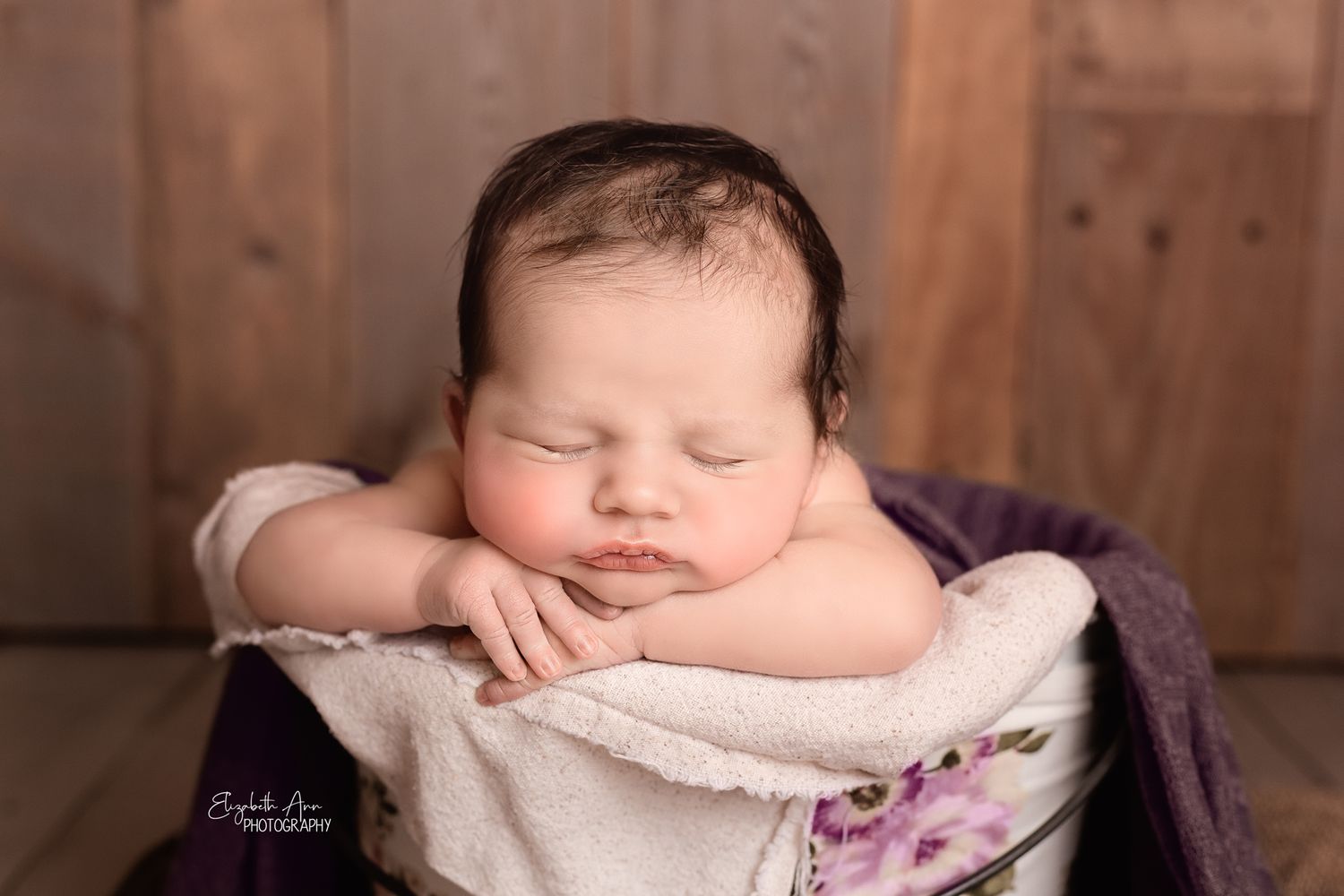 Closeup of newborn baby asleep in a bucket with barn wood backdrop; Elizabeth Ann Photography Wisconsin