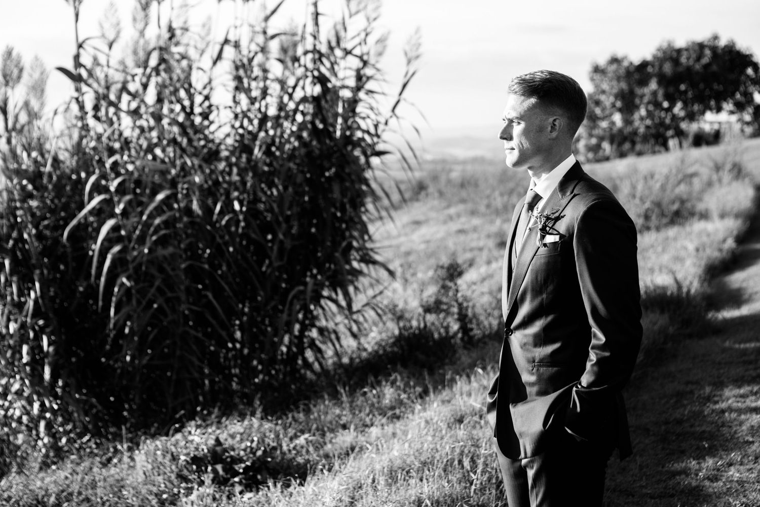 Black and white portrait photography of the groom at a destination wedding in Tuscany.