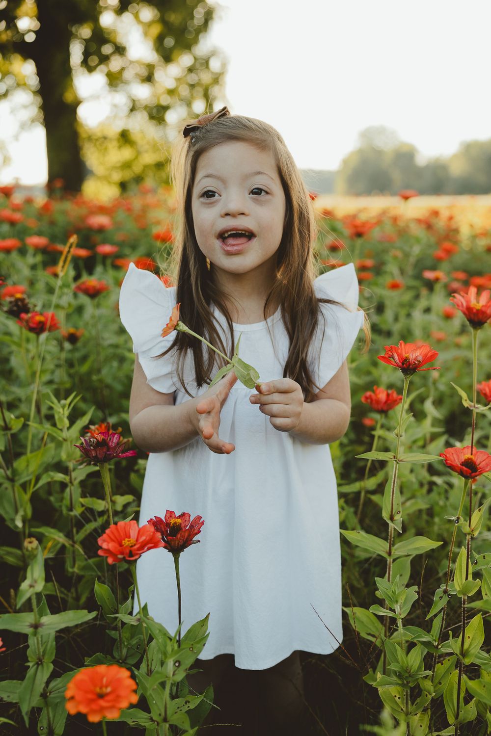 A cheerful moment captured in a poppy field with a white-dressed child among bright red blooms.