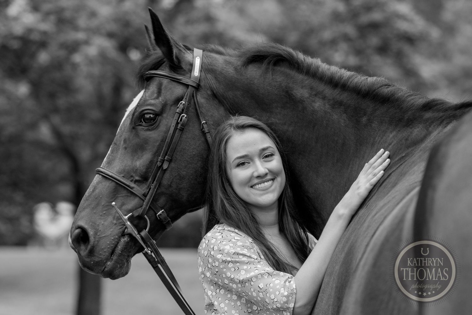 A black and white portrait with a bay horse showing an intimate bonding moment.
