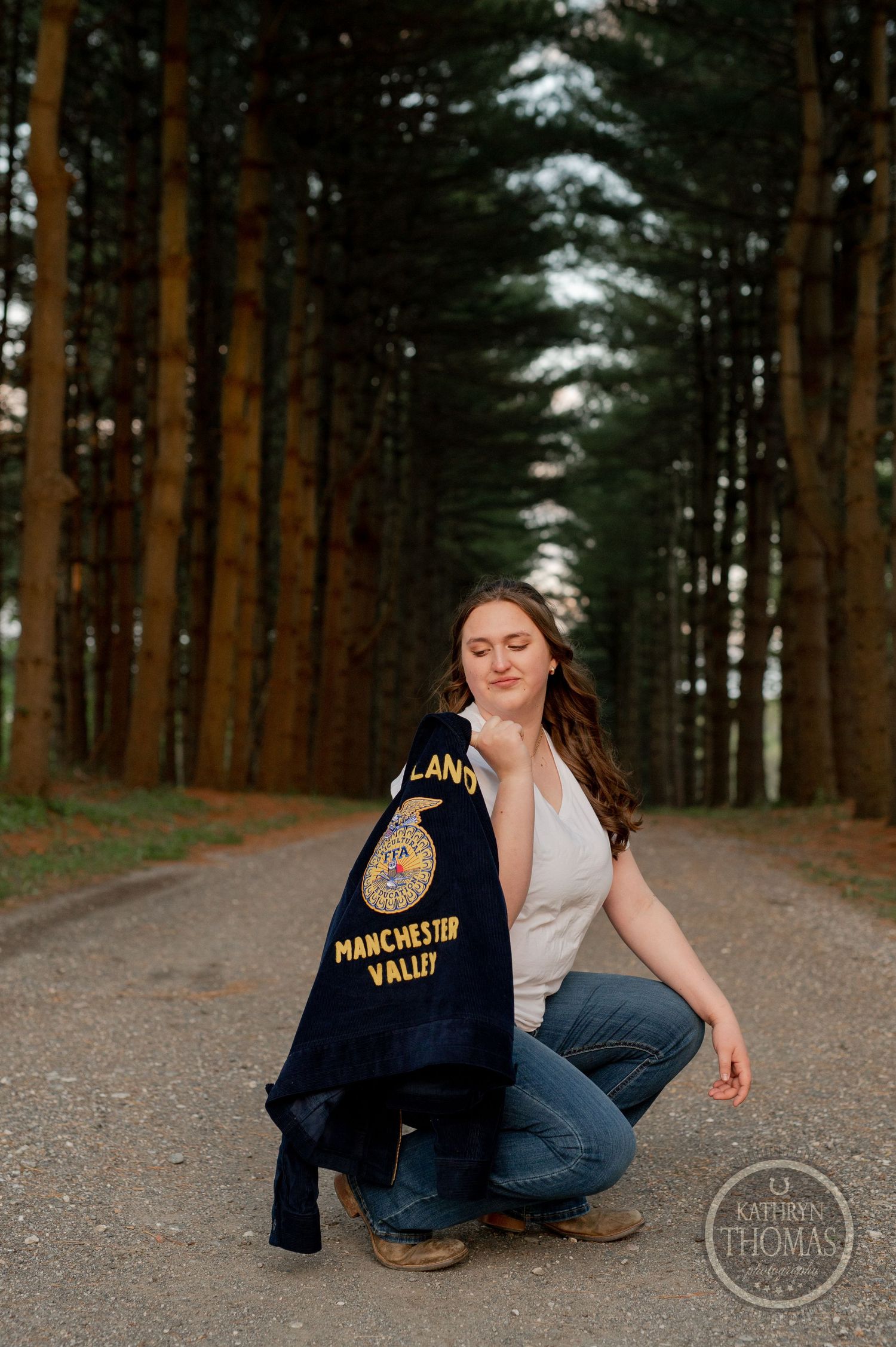 A casual portrait on a forest path showing off an FFA jacket at sunset.