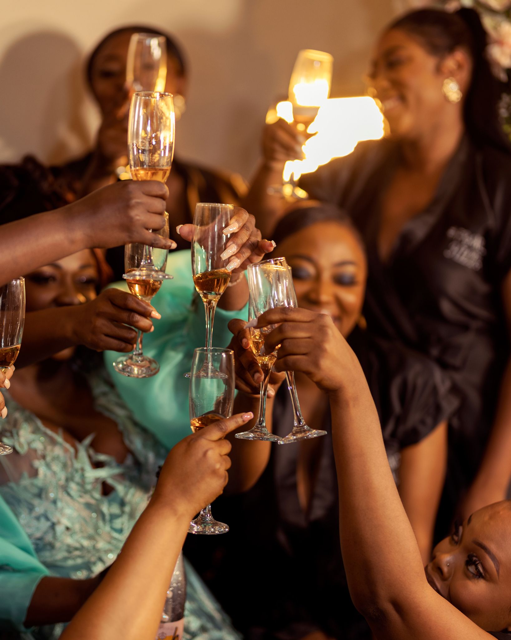Wedding guests raising champagne glasses in a celebratory toast.